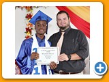 Valedictorian of the WHS Class of 2016, Naaman Rolle, receiving an award in Computer from teacher Mr. Yates - 490A3263